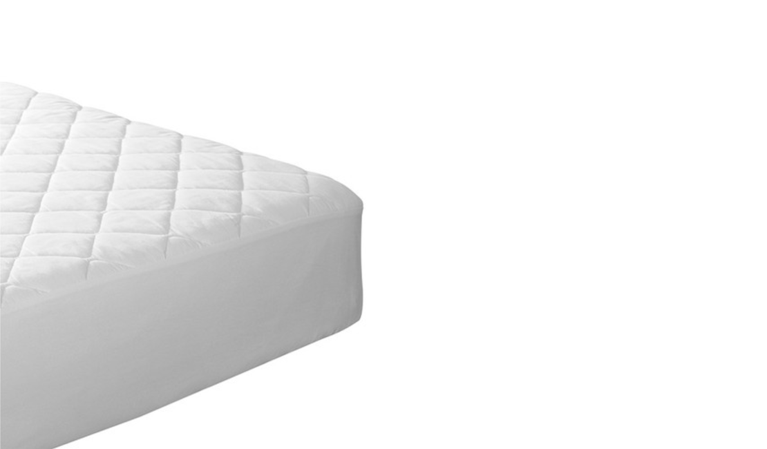 Bottom corner of a bed covered with the Imagem Quilted Mattress Protector.