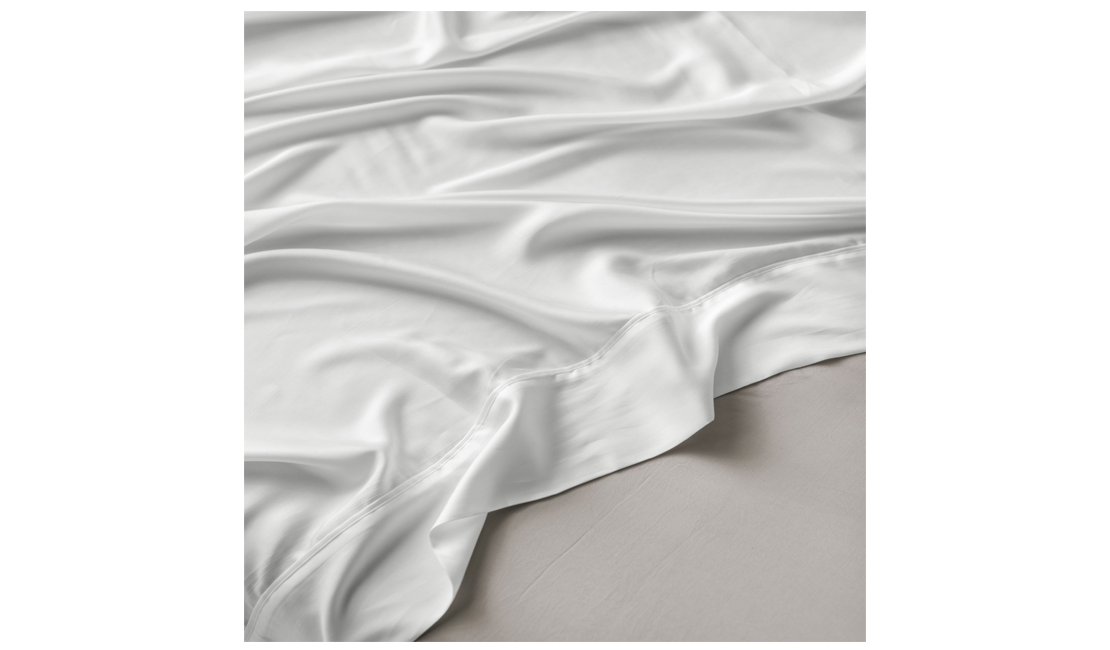 White silk sheet over a grey bamboo fitted sheet.