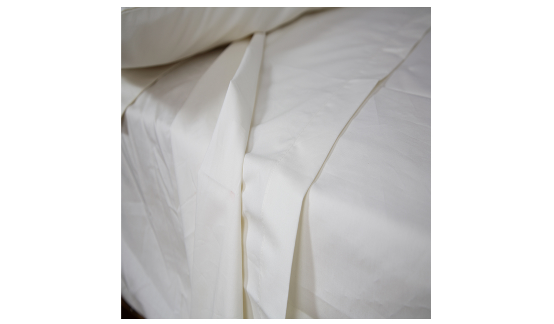 White flat sheet over white under sheet.