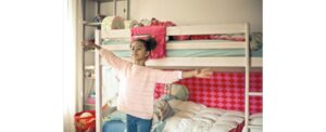 Young girl in front of a kids' bunk bed